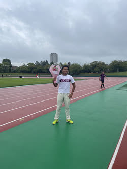 Ananda holding flowers on the track the day before leaving Japan
